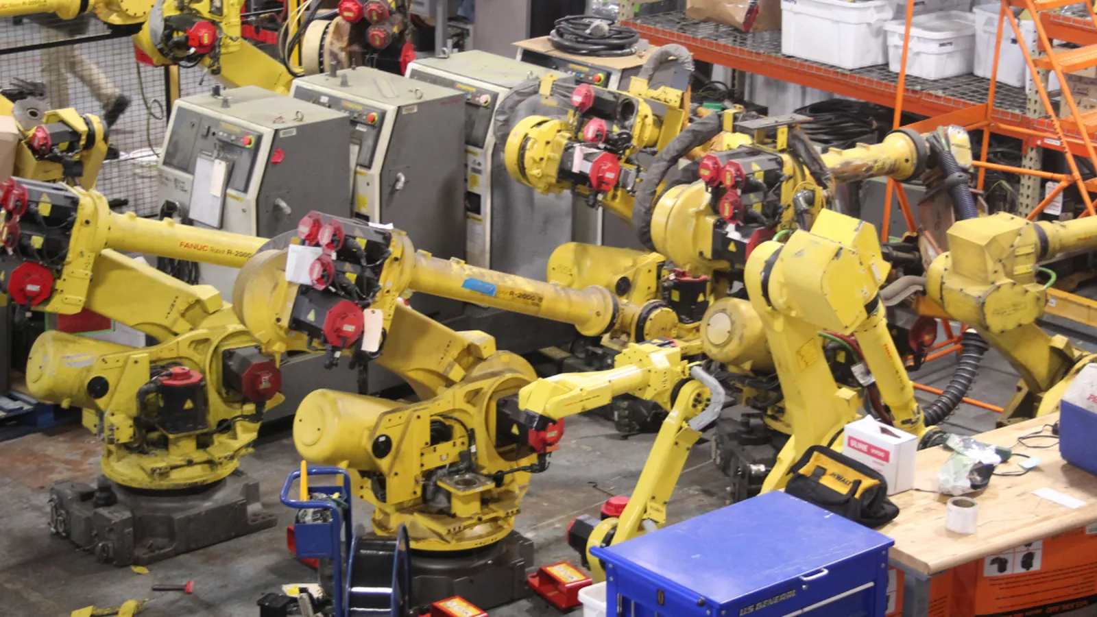Row of refurbished Fanuc industrial robots on the T.I.E. Industrial floor